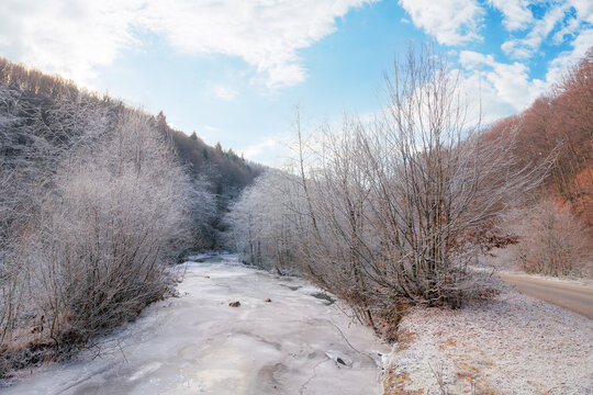 frozen river among forest on a frosty morning. mountainous carpathian landscape in winter