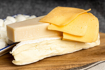 Celebrating the Jewish holiday Shavuot. Kosher fresh dairy products. Various cheeses. Dairy products on a wooden background.