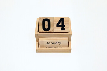 4th of January wooden perpetual calendar. Shot close up isolated on a white background 
