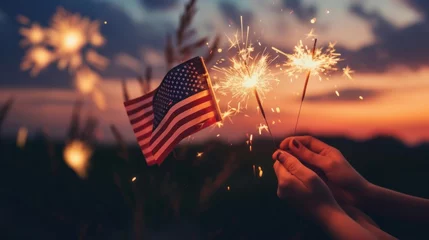 Foto op Plexiglas People celebrating holiday holding US flag and sparklers, fireworks in background © Elvin
