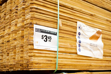 Wooden cedar pickets in polyester strapping, price tag, full pallet packaging at hardware home improvement store, Dallas, Texas, durable 1x6 pickets unfinished natural look dog ear privacy top