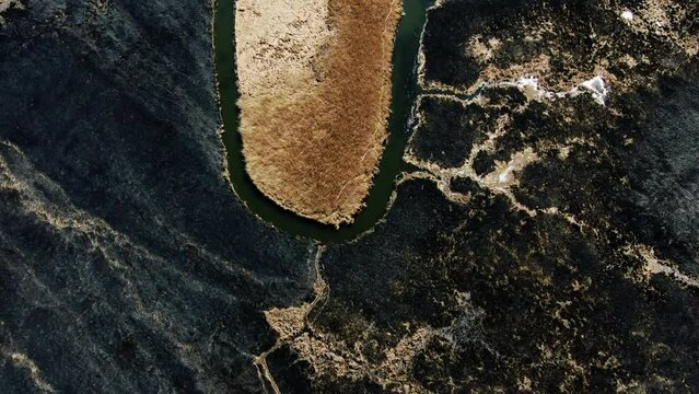 Aerial View of Isolated Water Body in Burnt Landscape