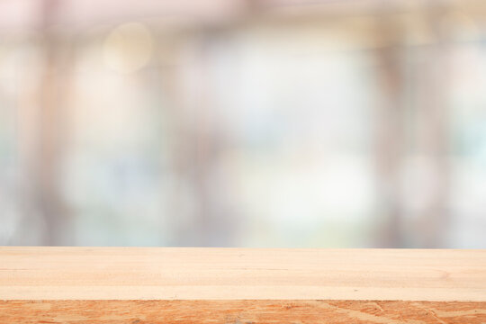 wooden table on blurred window background for displaying product mockup