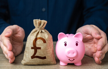 Savings are protected. Protect piggy bank and british pound sterling money bag. Safety of investments. Secured loans and mortgages. Defense budget. Social support. Retirement money funds.