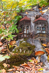 Forest fairy-tale landscape with housing in an old stump