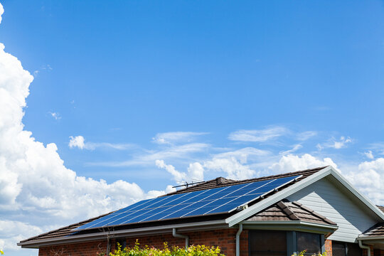Roof filled with solar panels and big blue sky with copy space