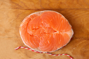 For baking, a piece of salmon is wrapped in a circle and tied with a string