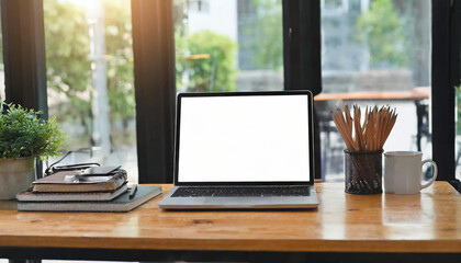 Close-up view of open blank screen laptop computer with office supplies in modern office