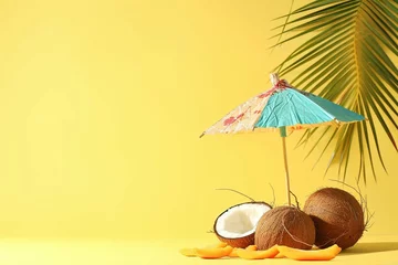Foto op Canvas Tropical beach concept made of coconut fruit and sun umbrella. Creative minimal summer idea. © Areesha