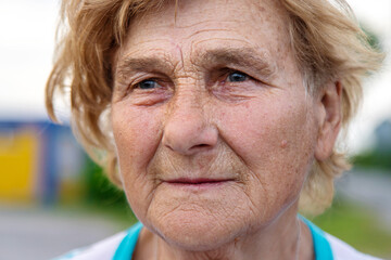 Old woman in the garden. Selective focus.
