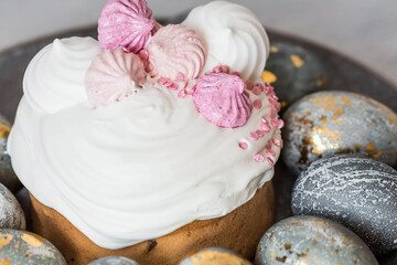 Beautiful stylish still life. Easter cake with meringue, marshmallows, and Easter eggs on a dark background. happy Easter 2024.