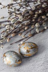 Stylish grey Easter eggs made of marble and concrete with a golden potala on a grey background. Coloring eggs with natural dye karkade tea. . The concept of a happy Easter.