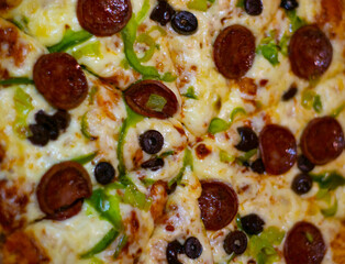 Close up shots of a delicious pepperoni pizza with Mozzarella cheese, salami, pepper, and fresh olives  Italian pizza