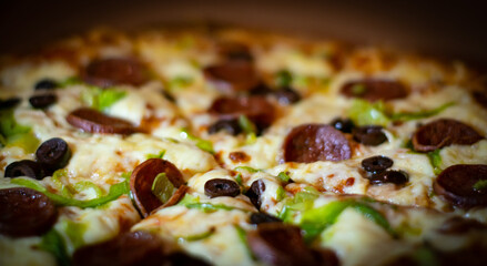 Close up shots of a delicious pepperoni pizza with Mozzarella cheese, salami, pepper, and fresh olives  Italian pizza