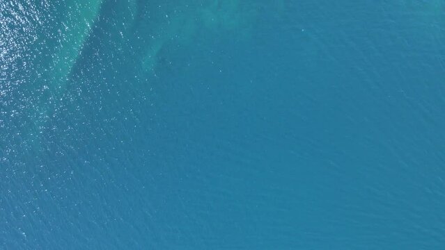 Overhead 4K drone clip over a rock formation in the tropical blue waters of Toroni in Chalkidiki