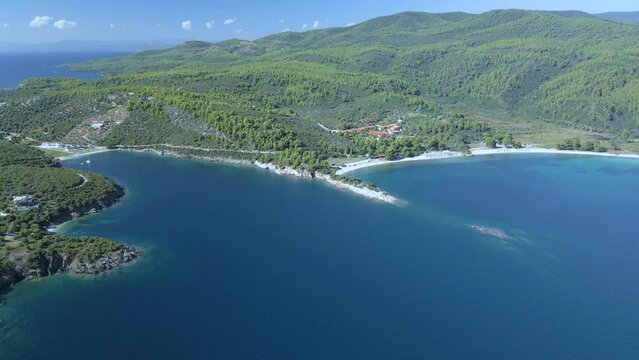 Cinematic downwards moving 4K drone clip over the tropical blue waters of Toroni in Chalkidiki