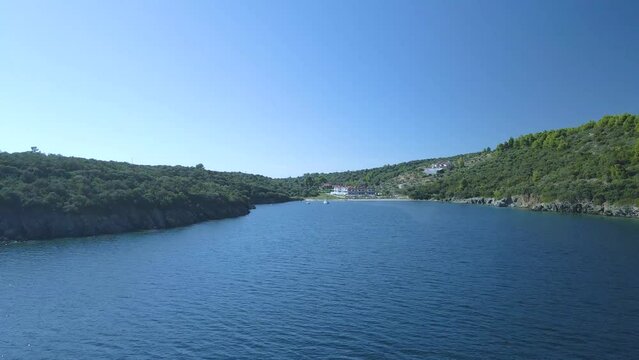 Cinematic forward moving towards some villas 4K drone clip over the tropical blue waters of Toroni in Chalkidiki