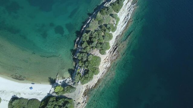 Overhead 4K drone clip over a rock formation in the tropical blue waters of Toroni in Chalkidiki
