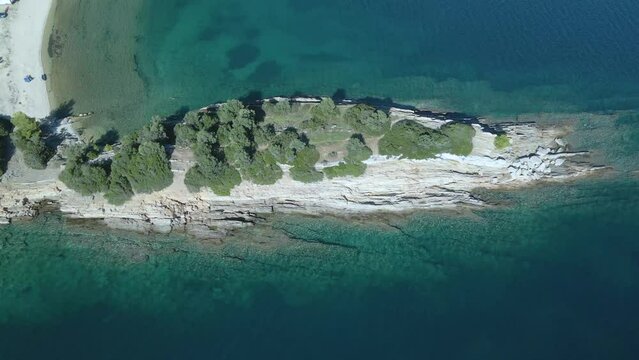 Overhead 4K drone clip over a rock formation in the tropical blue waters of Toroni in Chalkidiki
