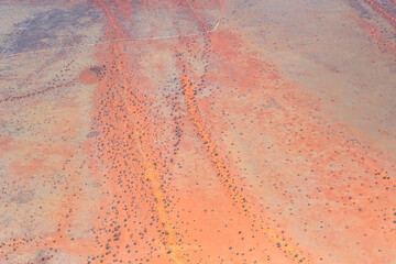 gravel road and dune stripes in Kalahari, east of Kalkrand, Namibia