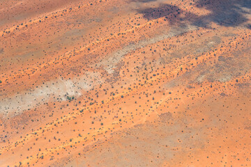 water hole and dune stripes in Kalahari, east of Kalkrand, Namibia