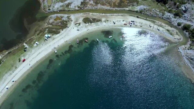 Cinematic slowly tilting up 4K drone clip over the tropical blue waters of Toroni in Chalkidiki