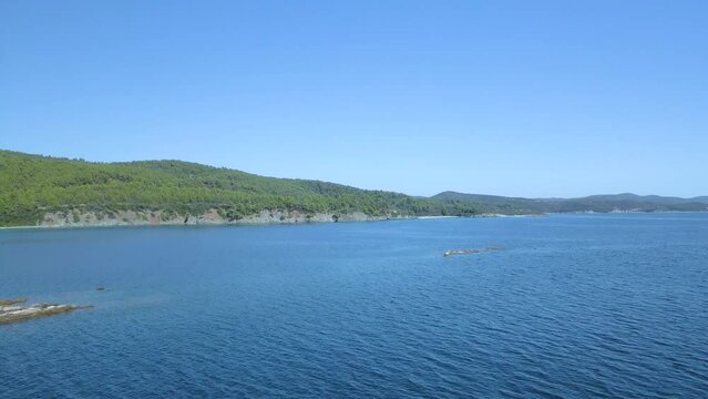 Cinematic forward moving 4K drone clip over the tropical blue waters of Toroni in Chalkidiki