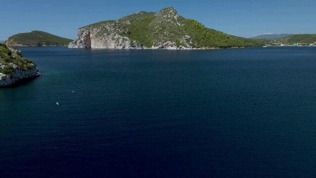 Cinematic sidweways moving 4K drone clip over the tropical blue waters of Toroni in Chalkidiki