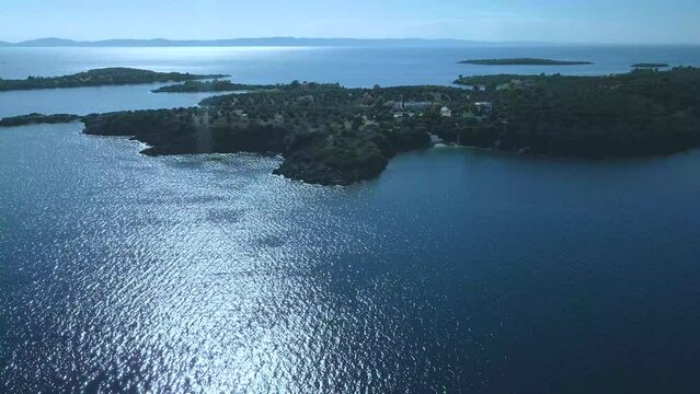 Cinematic rotating up high 4K drone clip over the tropical blue waters of Toroni in Chalkidiki