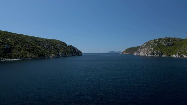 Cinematic forward moving 4K drone clip over the tropical blue waters of Toroni in Chalkidiki