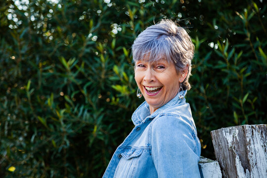 portrait of a senior woman smiling in the garden