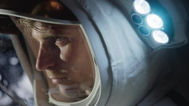 Portrait of an Excited Happy Man Astronaut Wearing a Helmet and Space Suit, Looking at the Universe Sunrise From Outer Space. Sci-Fi Cosmos Expedition, Discovery and Exploration of the Galaxy