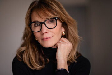 Close-up portrait of an attractive mid aged woman smiling to the camera