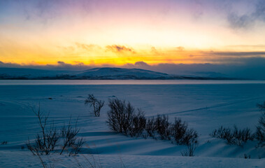 Pink sky and blue snow. Winter sunset in Finland