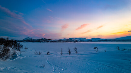 Fototapeta na wymiar Pink sky and blue snow. Winter sunset in Finland