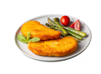 Chicken schnitzel with sauce, fried potatoes and lemon in a plate