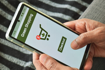 Person using mobile application to purchase environmentally preferable products. Sustainable...