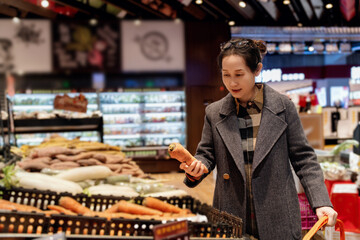 Elegant Woman Choosing Fresh Vegetables at Grocery Store