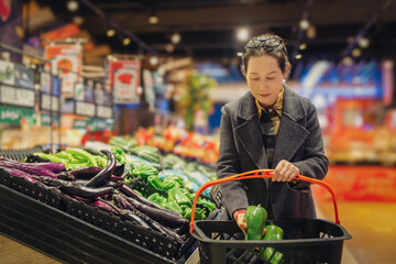Woman Choosing Fresh Vegetables in Grocery Store