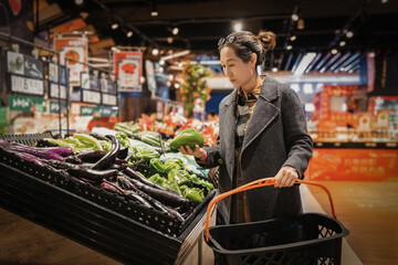 Woman Choosing Fresh Vegetables in Supermarket