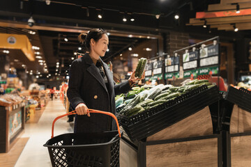 Elegant Woman Picking Fresh Vegetables at Supermarket