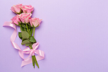 Pink roses with hearts on color background, top view. Valentines day concept
