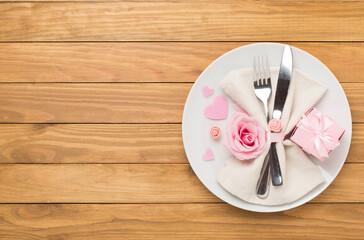 Festive table setting for Valentine's Day on wooden background, top view