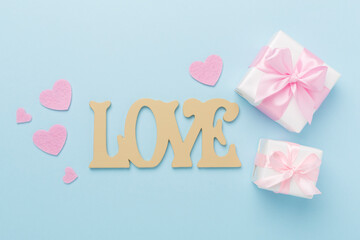 Valentines day composition with gifts on color background, top view.