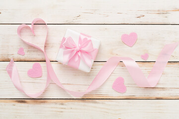 Valentines day composition with gifts on wooden background, top view.