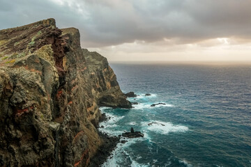 Fototapeta na wymiar Cliffs meet waves in harmony.