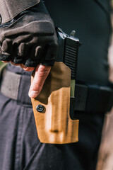 the guy puts the gun in the holster close-up