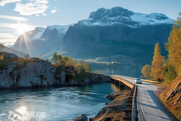 A solitary car traverses a winding bridge, surrounded by a breathtaking landscape of autumn trees, towering mountains, and a serene body of water, under a sky dotted with fluffy clouds