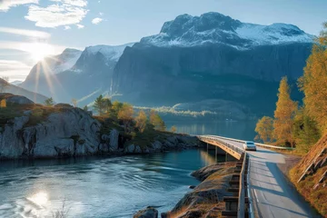 Store enrouleur Tower Bridge A solitary car traverses a winding bridge, surrounded by a breathtaking landscape of autumn trees, towering mountains, and a serene body of water, under a sky dotted with fluffy clouds