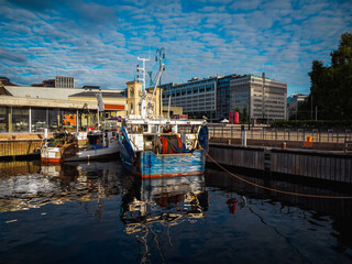 Fototapeta na wymiar two shrimp boats moored on a pier on a city wharf in the morning